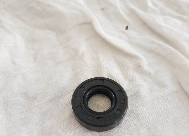 Retentor de borracha com guarda-pó sobre um pano claro